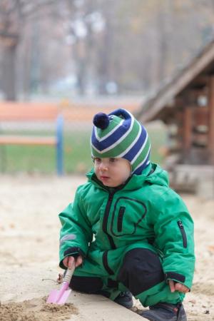 Young boy in sandpit
